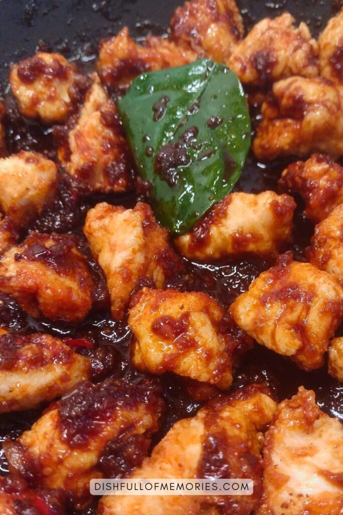 Indonesian Chicken Betawi dish being prepared in pan.