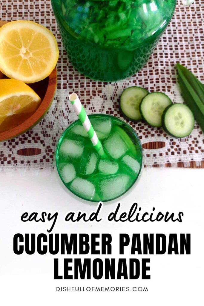 Glass of green lemonade with icecubes and drinking straw photgraphed from above with cucumber slices and lemons next to it. Text on image: Easy and delicious cucumber pandan lemonade. Dish full of memories dot com.