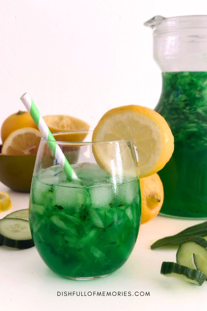 Tropical drink glass filled with green cucumber pandan lemonade.