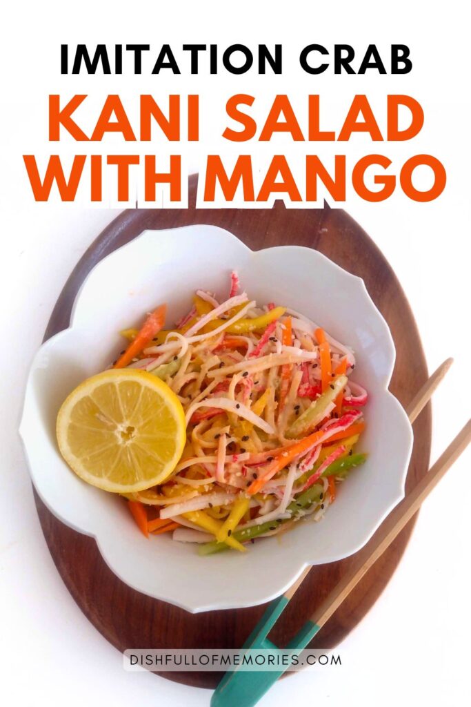White flower shaped bowl with salad and cut lemon on oval serving tray. Text on image: Imitation crab kani salad with mango. Dish full of memories dot com.